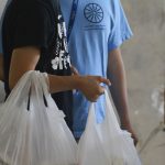 Residents in the parking garage of Gilliam Place pick up donations during COVID